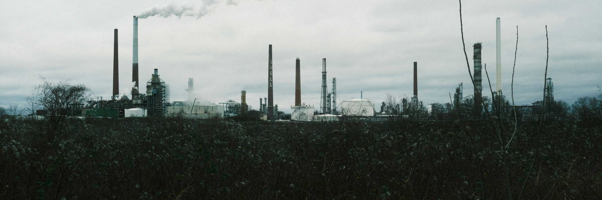 a factory with smoke coming out of its stacks