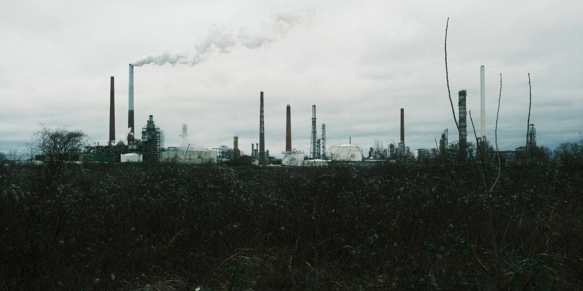 a factory with smoke coming out of its stacks