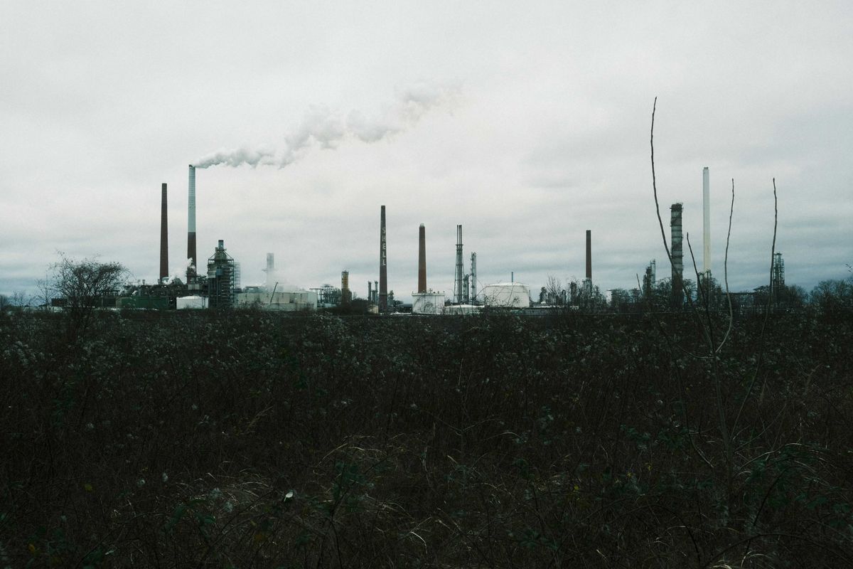 a factory with smoke coming out of its stacks