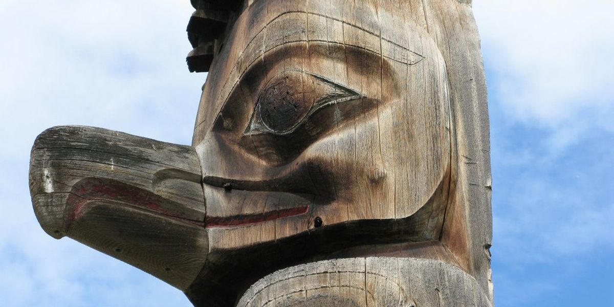 A First Nations wooden totem carved in the figure of a bird.
