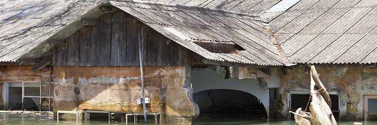 A flooded building with a metal roof