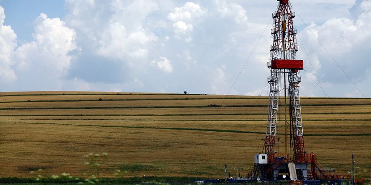 A fracking platform next to a farm field.