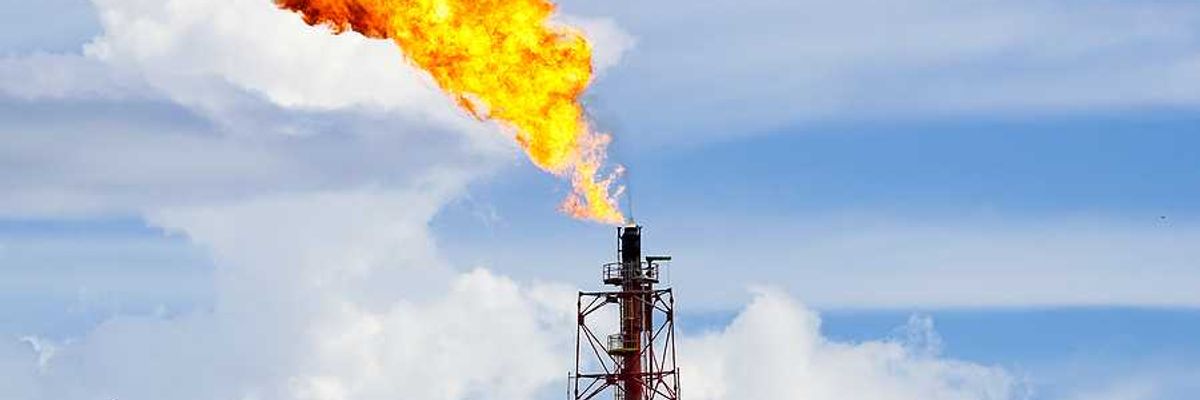 A fracking tower flaring flames into the sky