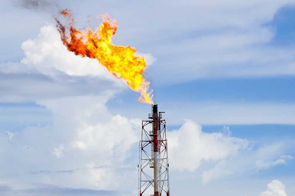 A fracking tower flaring flames into the sky
