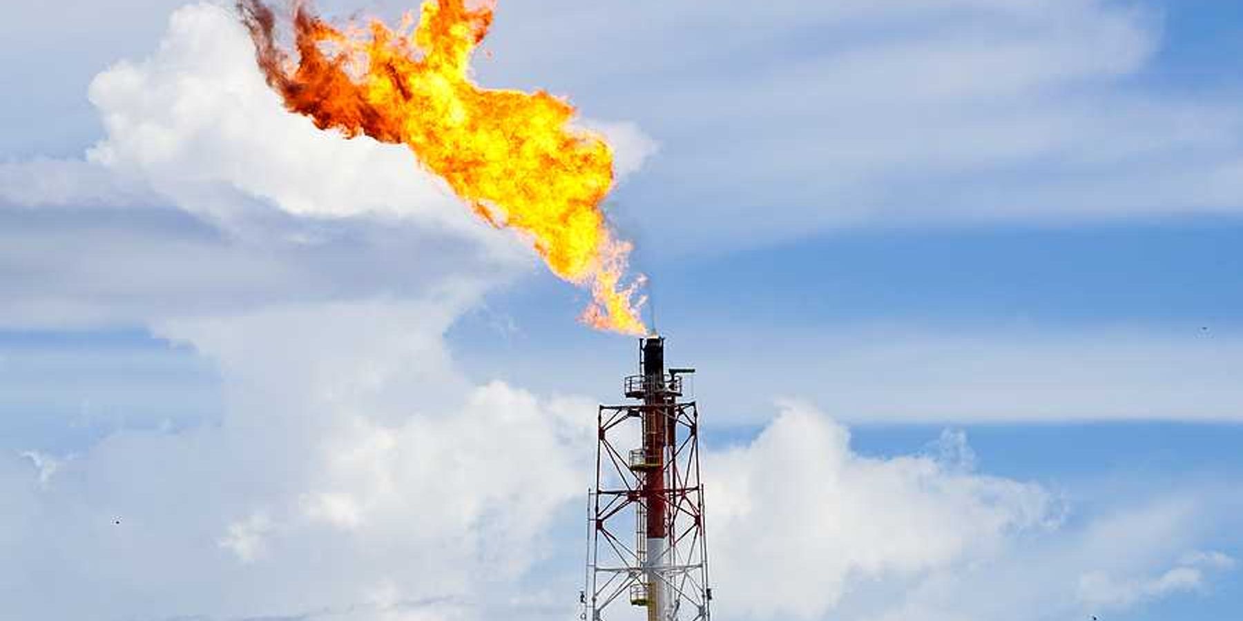 A fracking tower flaring flames into the sky