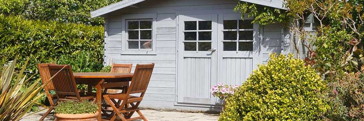 A garden shed with a patio in front of it