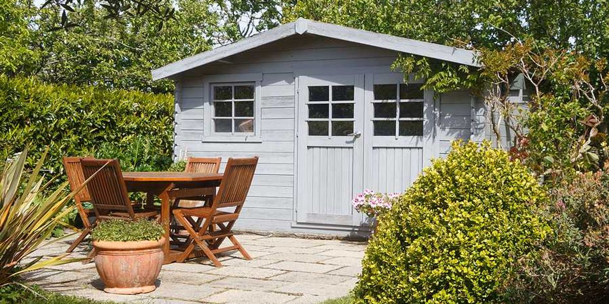 A garden shed with a patio in front of it