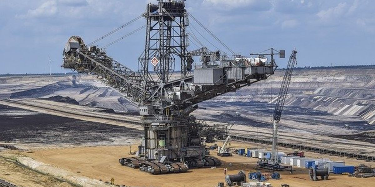 A giant crane in the middle of a mine pit.