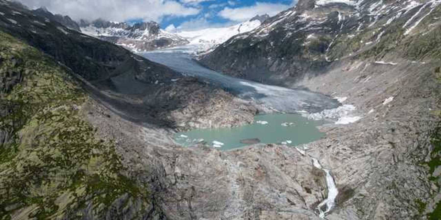 A glacial lake surrounded by snow capped mountains