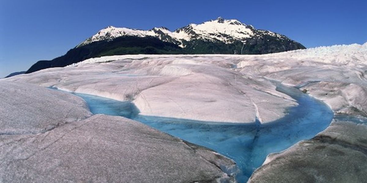 A glacier with a river running through it.