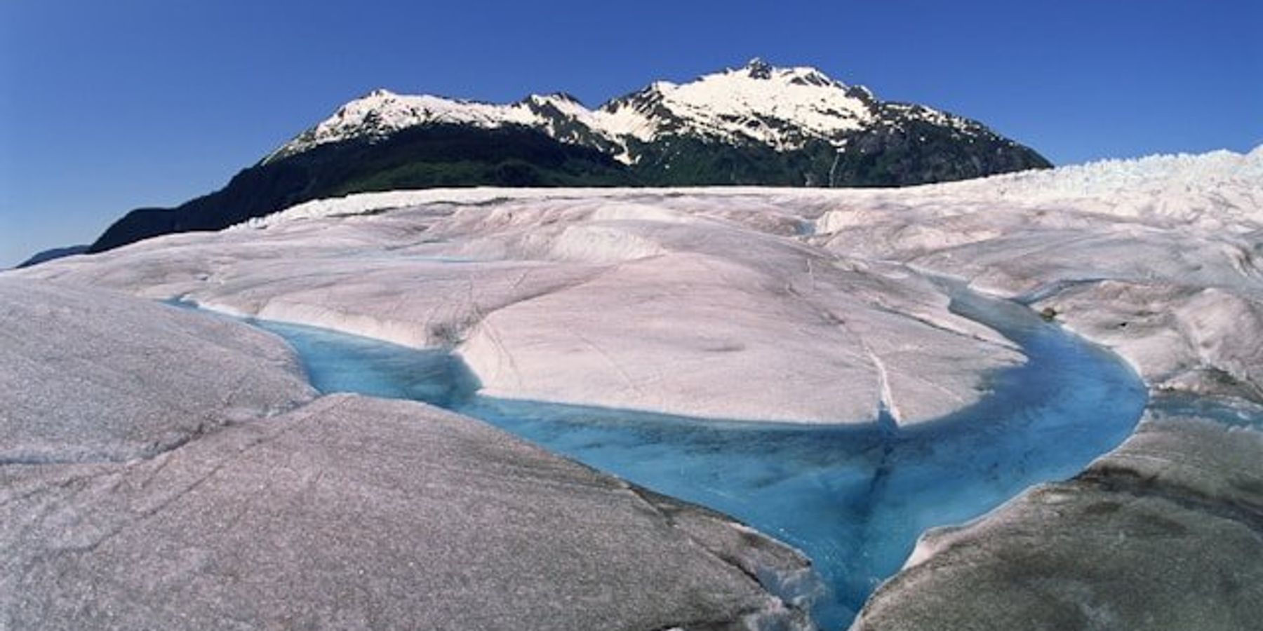 A glacier with a river running through it.