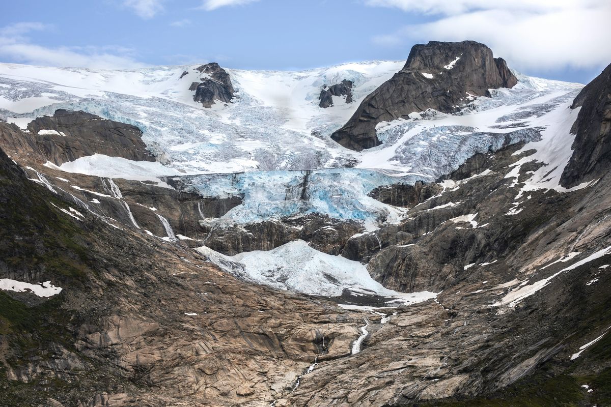 A Greenland glacier receding from a brown and gray valley
