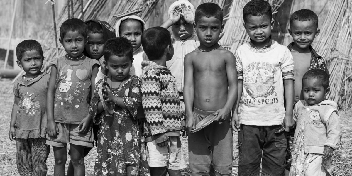 a group of children standing next to each other in a black and white photo