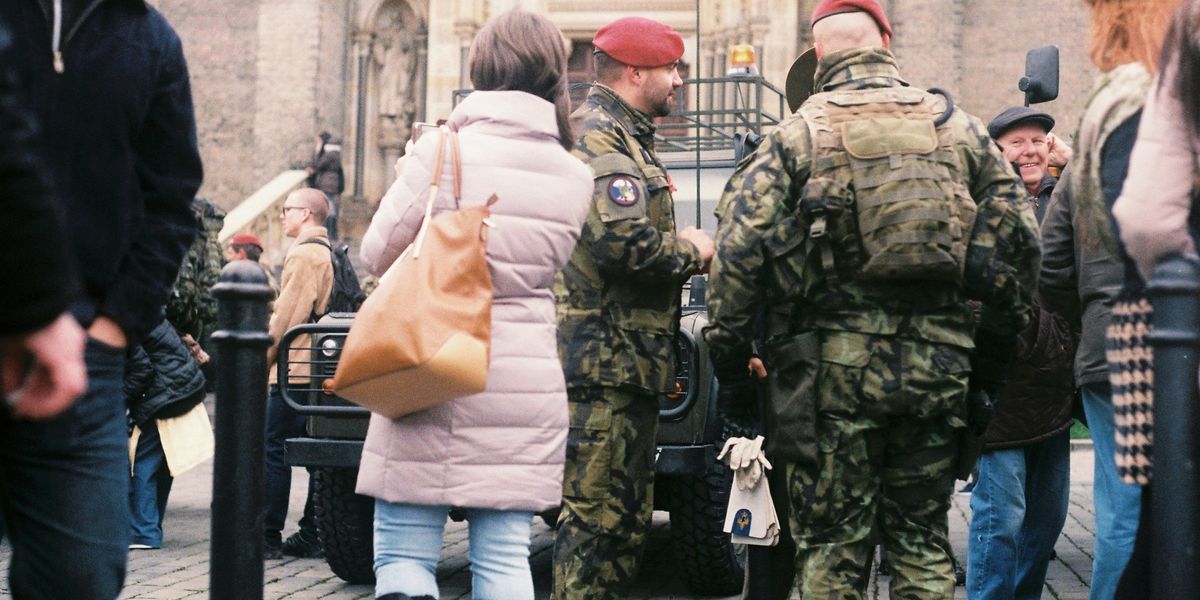 A group of Czechia soldiers standing in a crowd.