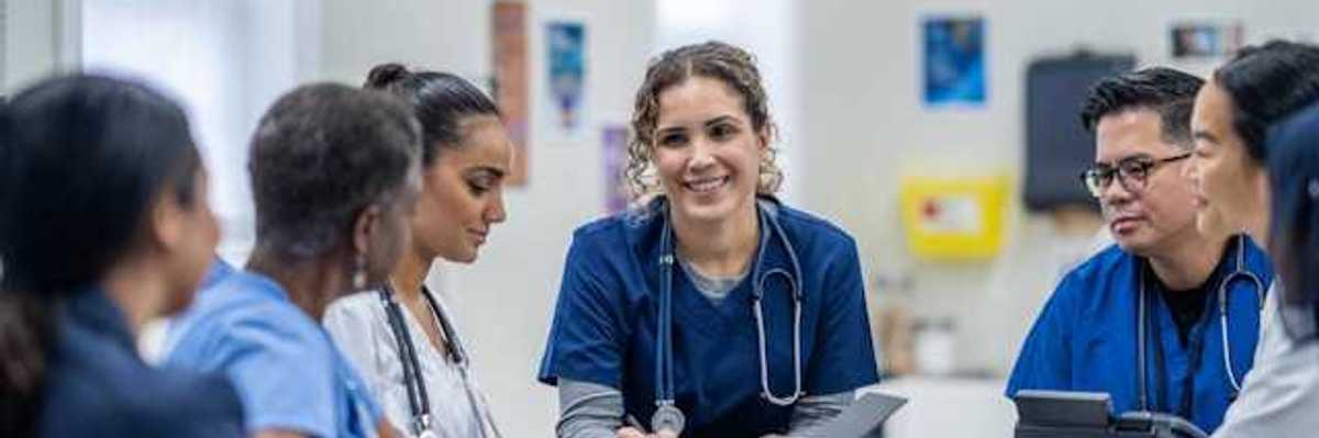 A group of health professionals reviewing a case file
