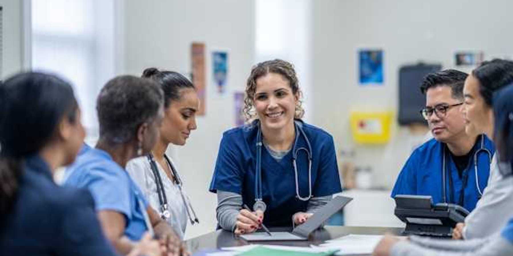 A group of health professionals reviewing a case file