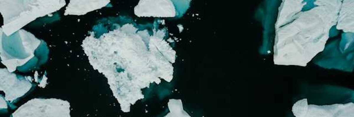 A group of icebergs floating around