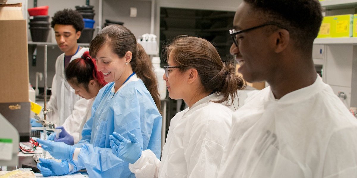 A group of young, diverse scientists work in a laboratory.
