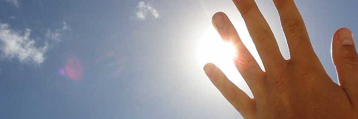 A hand blocking the sun's rays