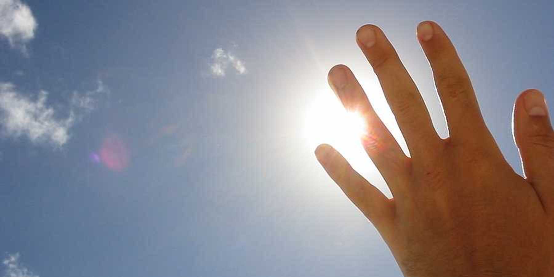 A hand blocking the sun's rays