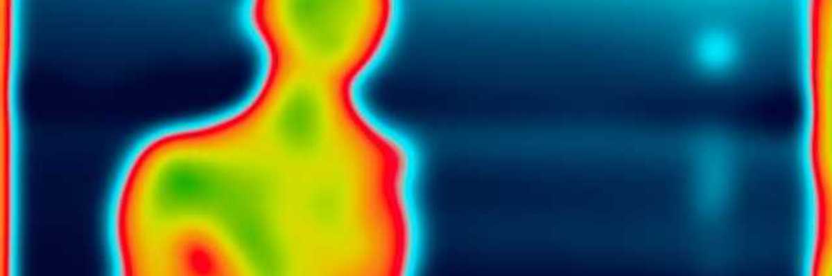 A heat image of a person silhouetted against a blue background