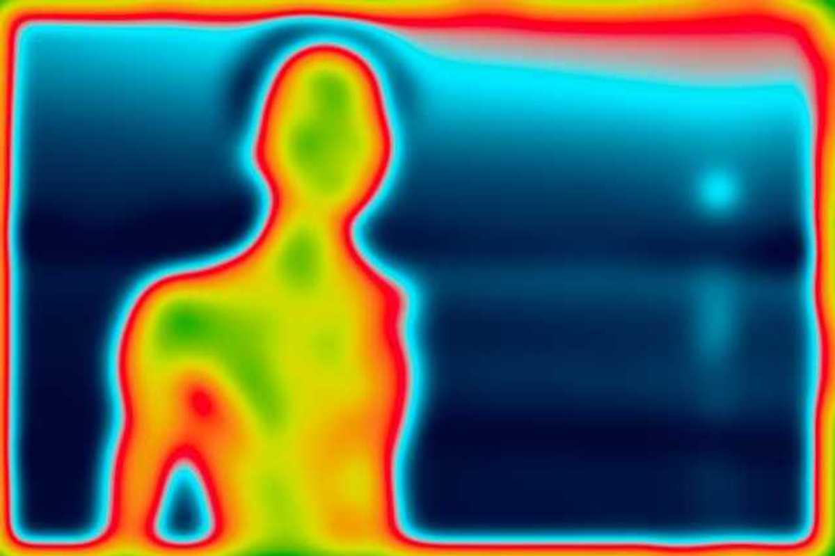 A heat image of a person silhouetted against a blue background