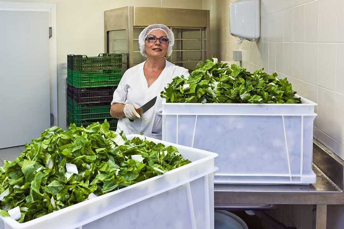 A hospital worker in a cafeteria kitchen