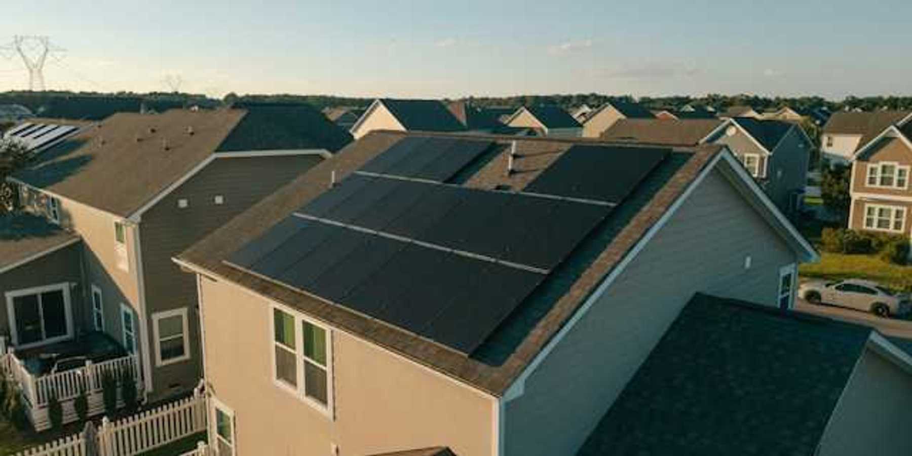 A housing tract with a house with solar panels on the roof