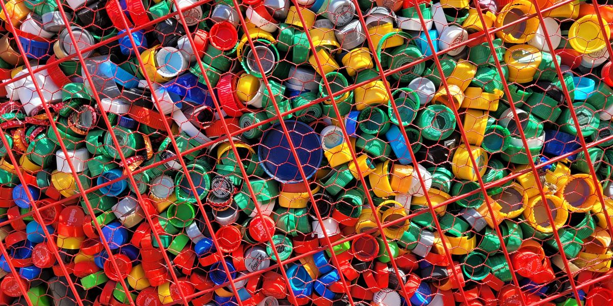 a large amount of plastic bottles in a cage.