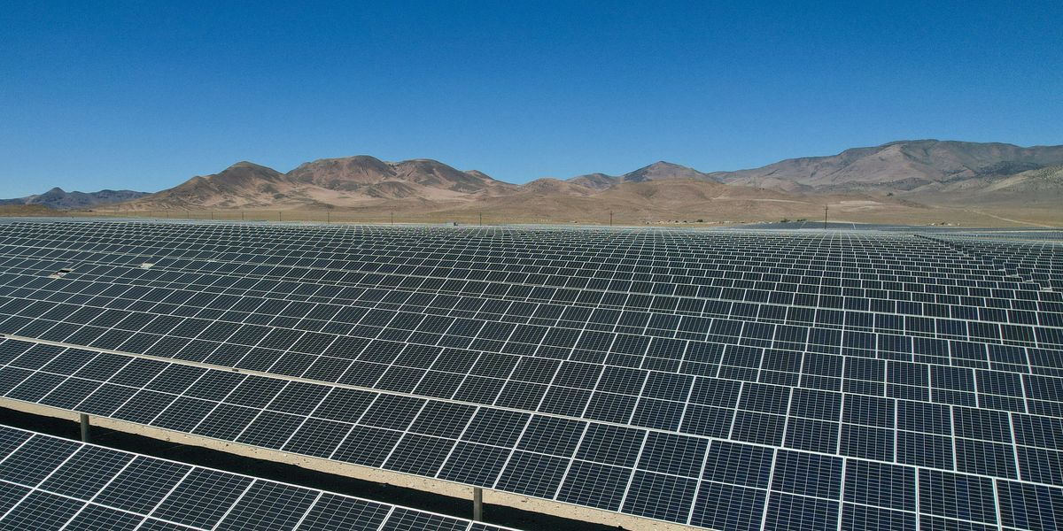 a large array of solar panels in a desert.