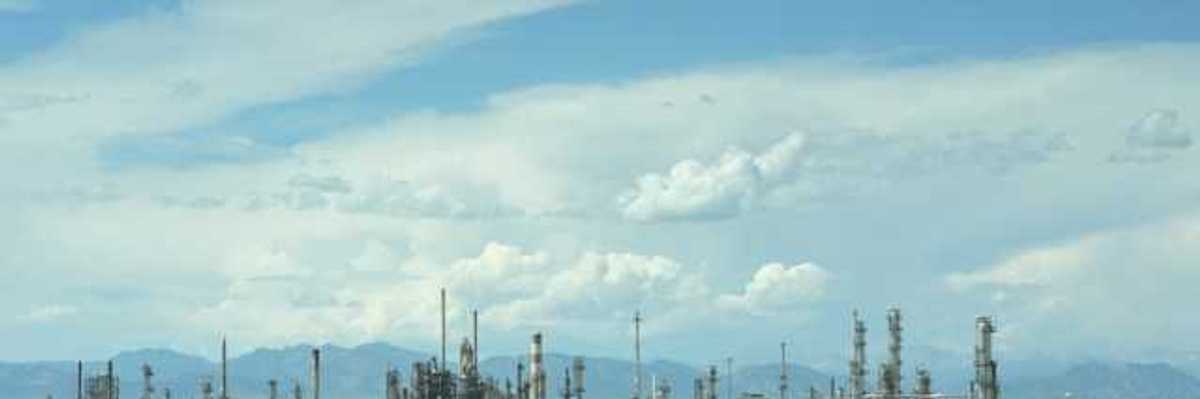 A large industrial area with smoke coming out of the stacks