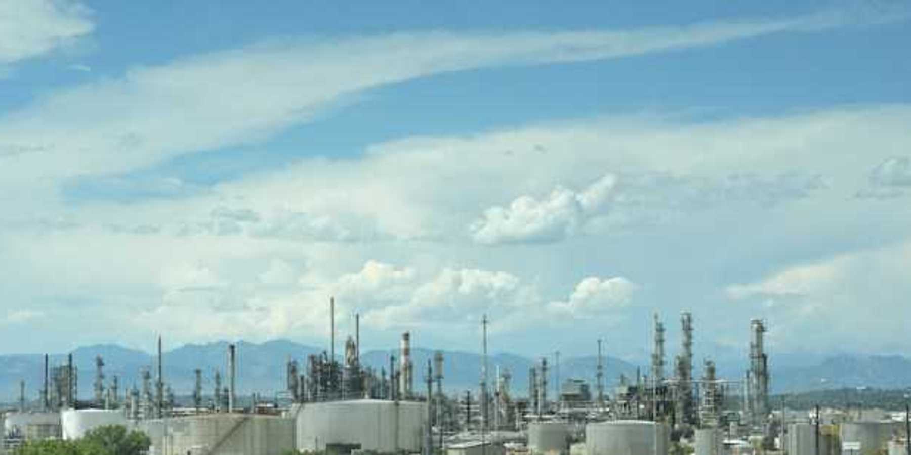 A large industrial area with smoke coming out of the stacks