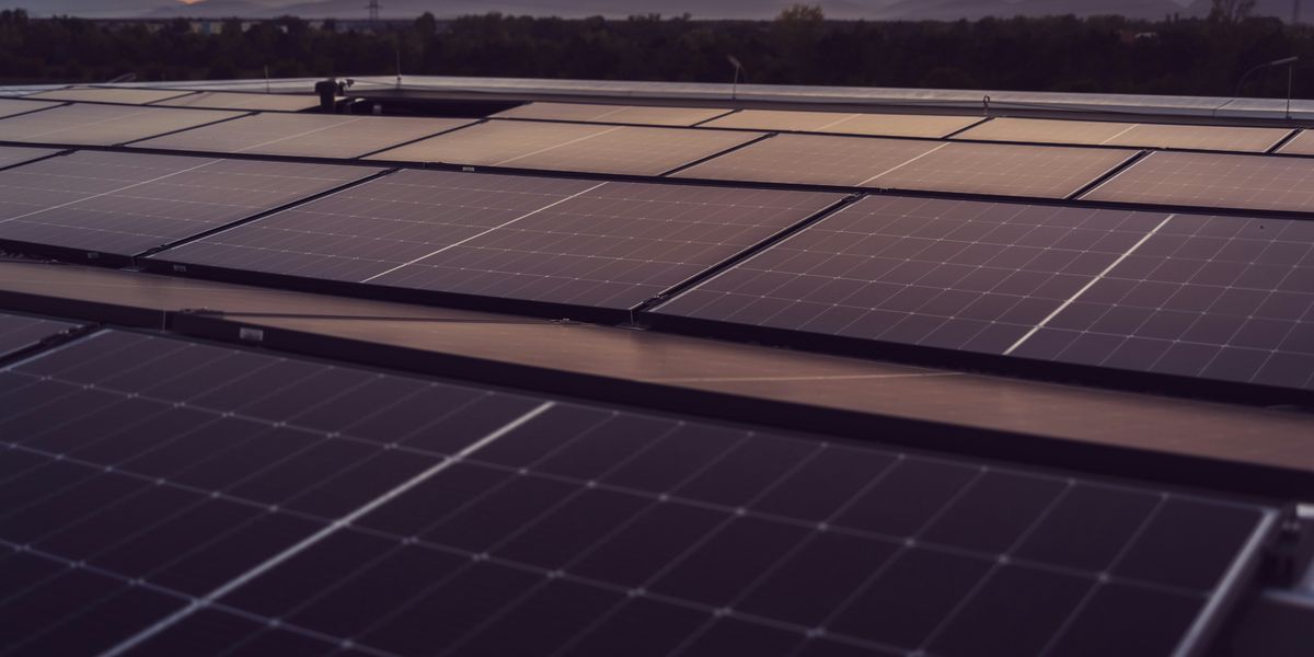 a large solar panel with mountains in the background.