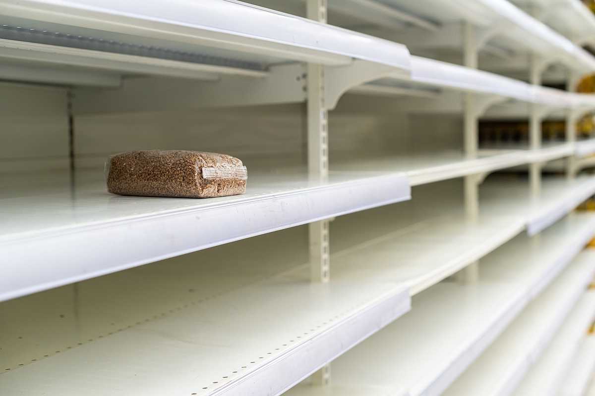 A lone package of grain on otherwise empty supermarket shelves