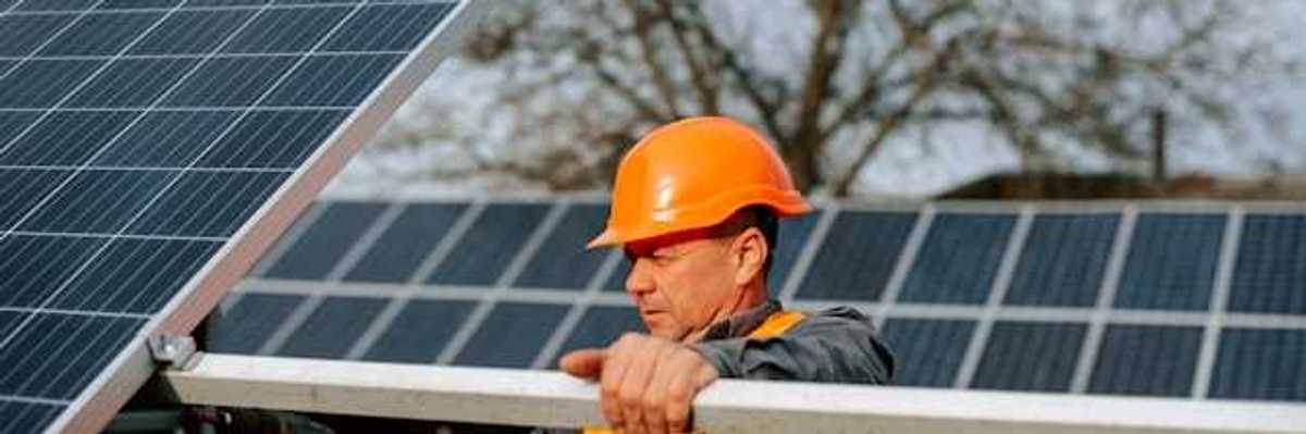 A maintenance worker installing solar panels