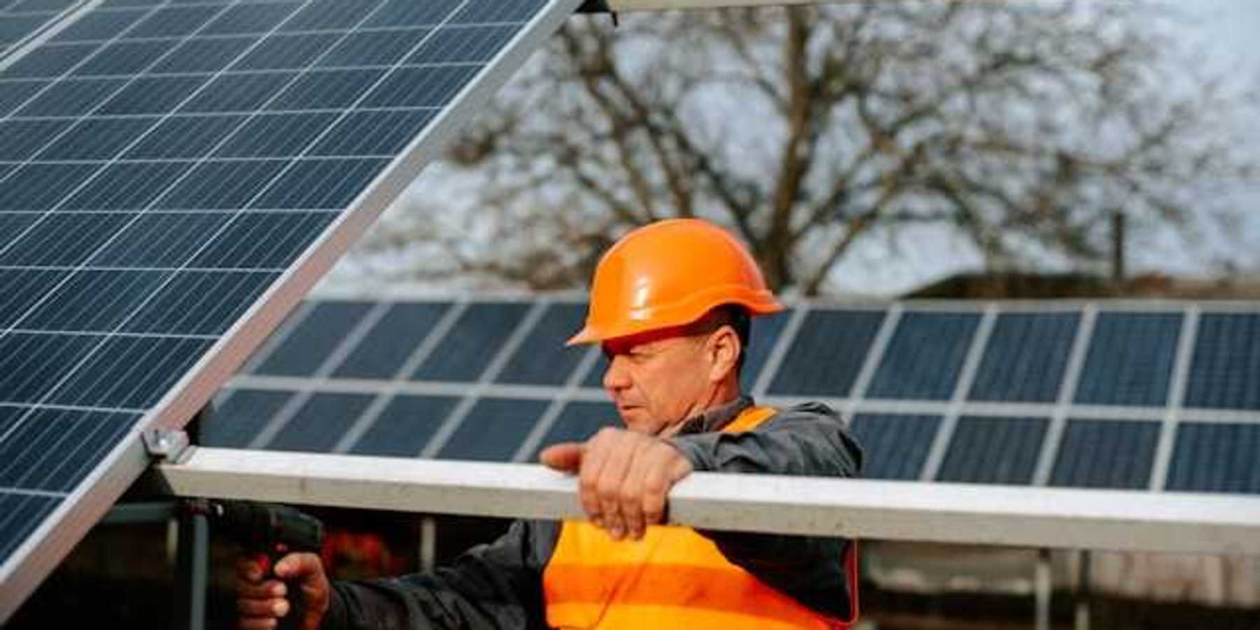 A maintenance worker installing solar panels