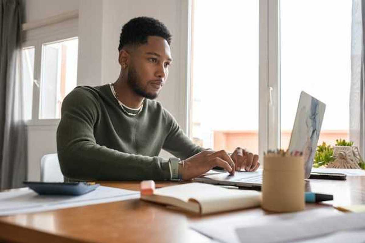 A man at a table working on a computer
