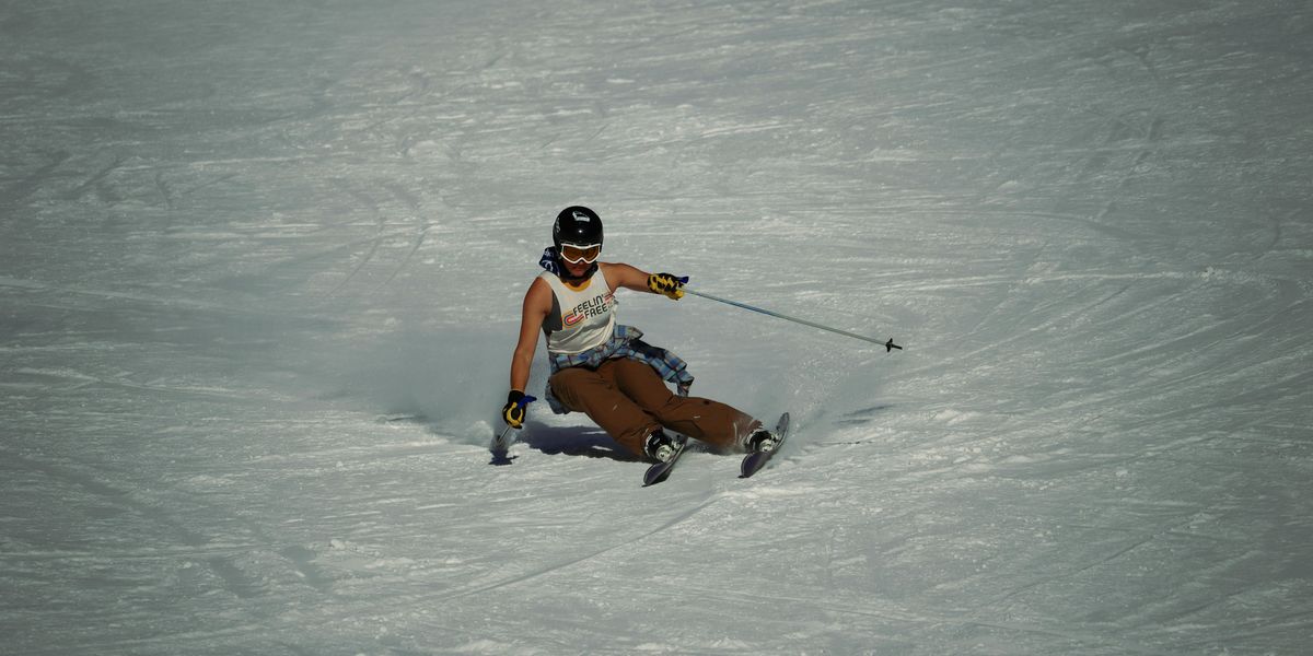 a man riding skis down a snow covered slope.
