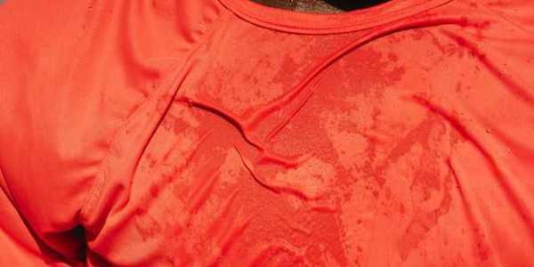 A man wearing a red shirt that appears to be wet