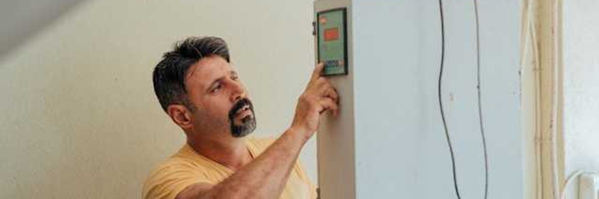 A man working on an installation of a heat pump