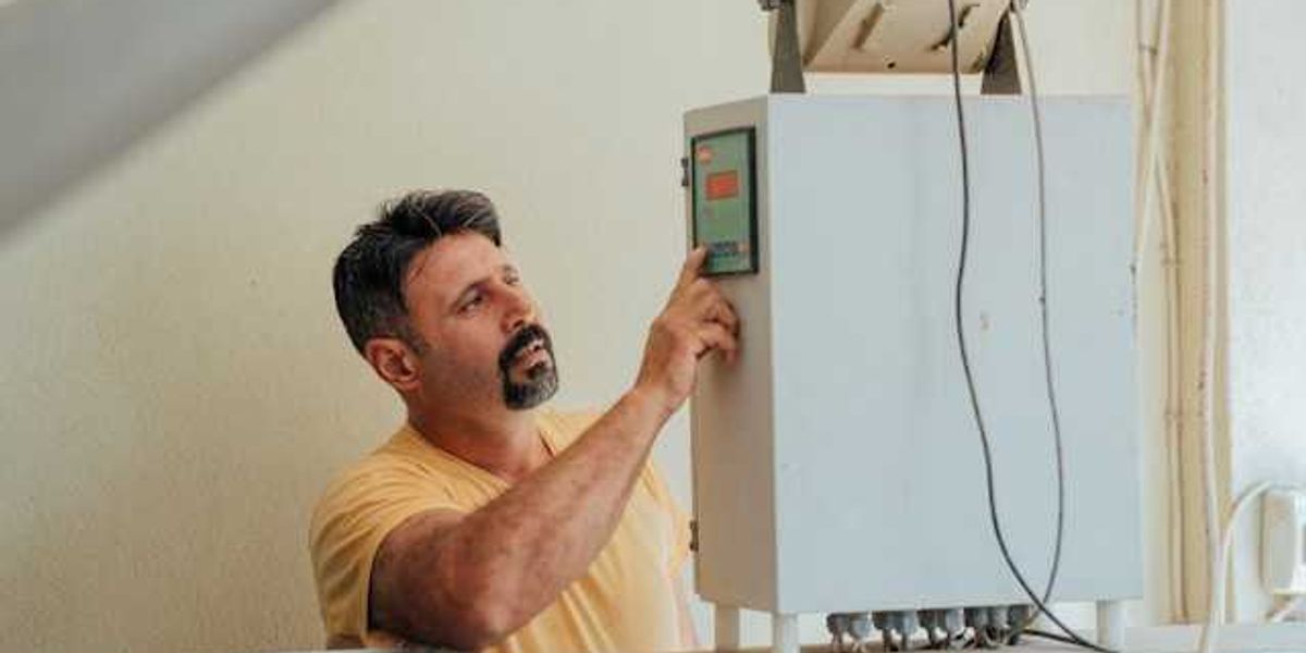 A man working on an installation of a heat pump