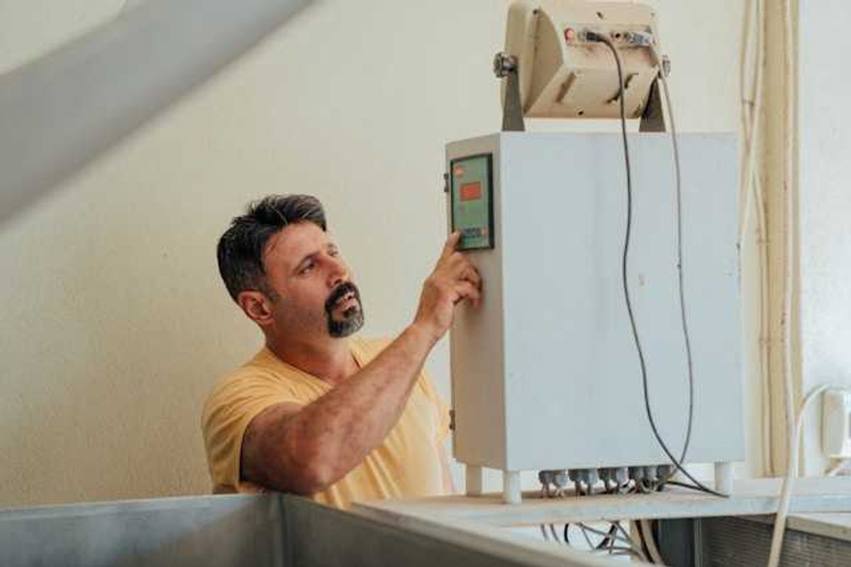 A man working on an installation of a heat pump