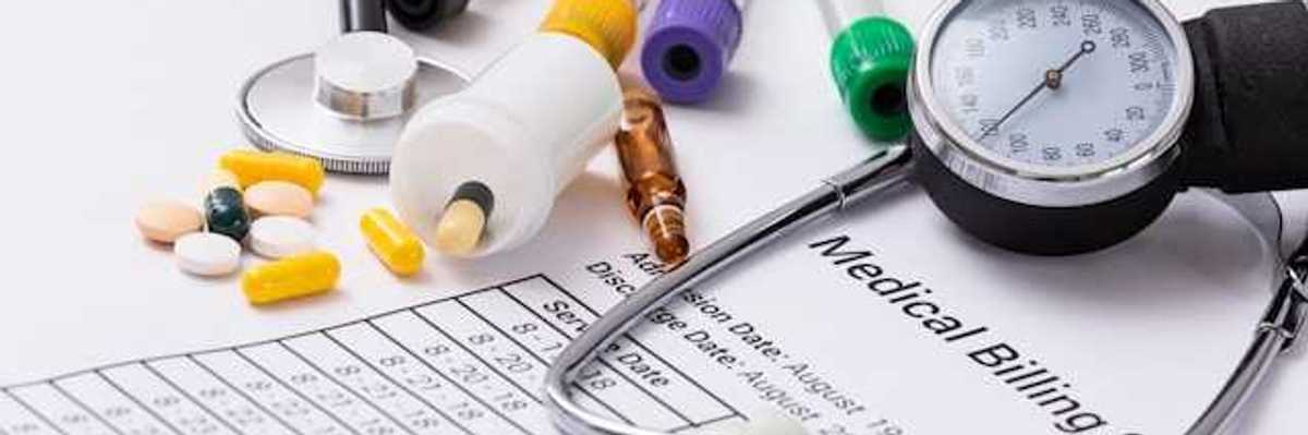 A medical billing statement with a stethoscope and assorted prescription pills next to it