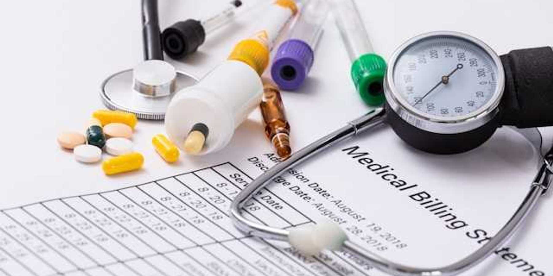 A medical billing statement with a stethoscope and assorted prescription pills next to it