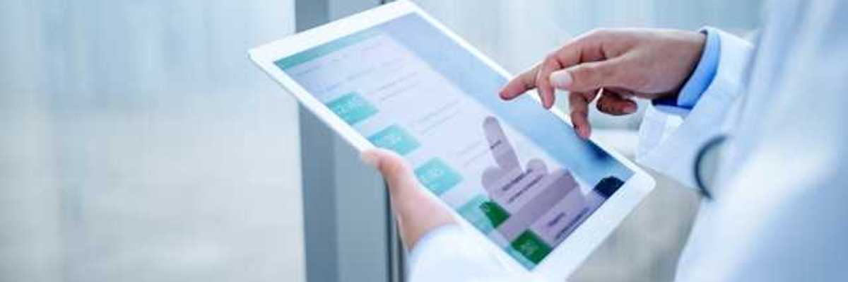 A medical professional holding a tablet