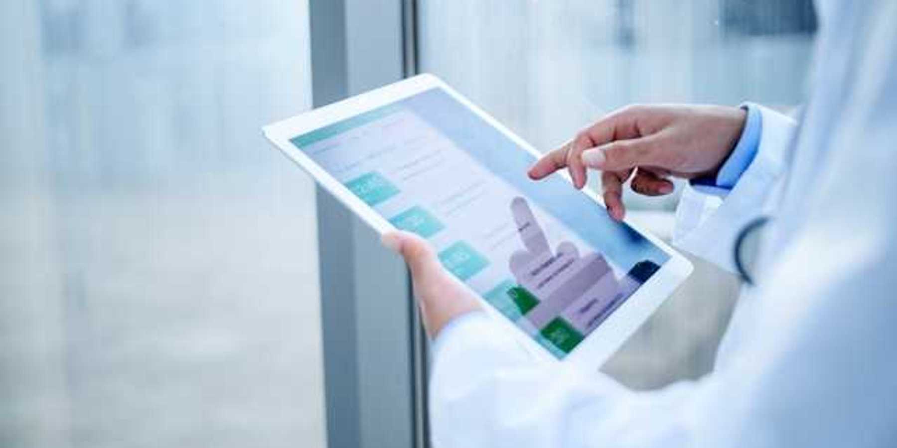 A medical professional holding a tablet