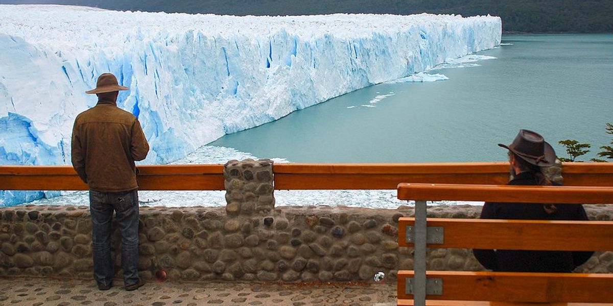 A person standing at a viewing platform of the Perito Moreno Glacier in Argentina.
