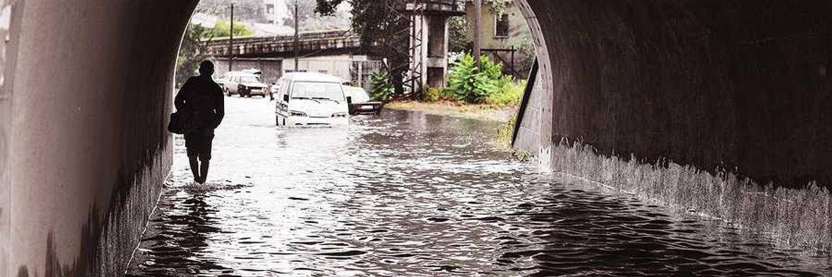 A person walking through a flooded underpass