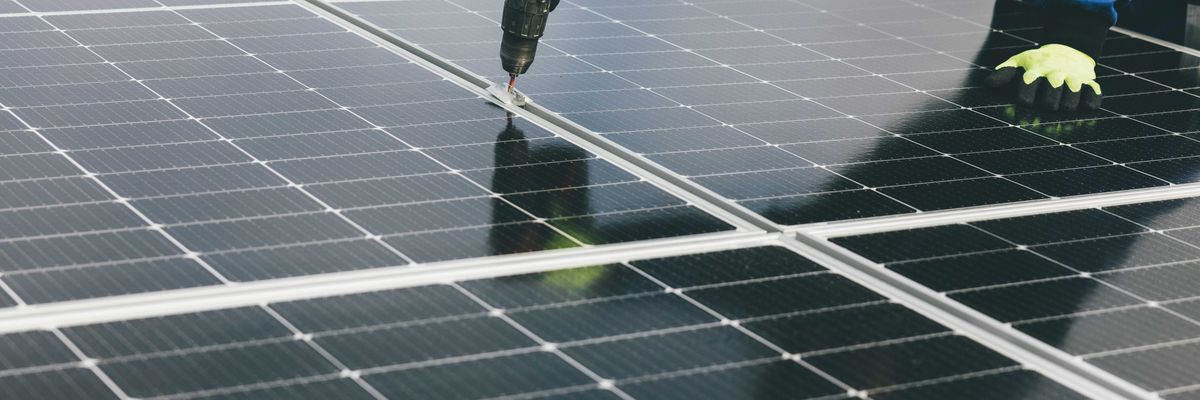 a person working on a solar panel.