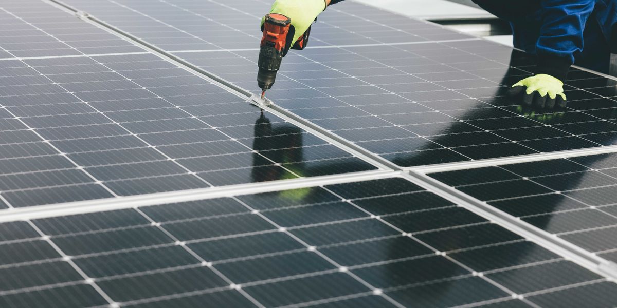 a person working on a solar panel.